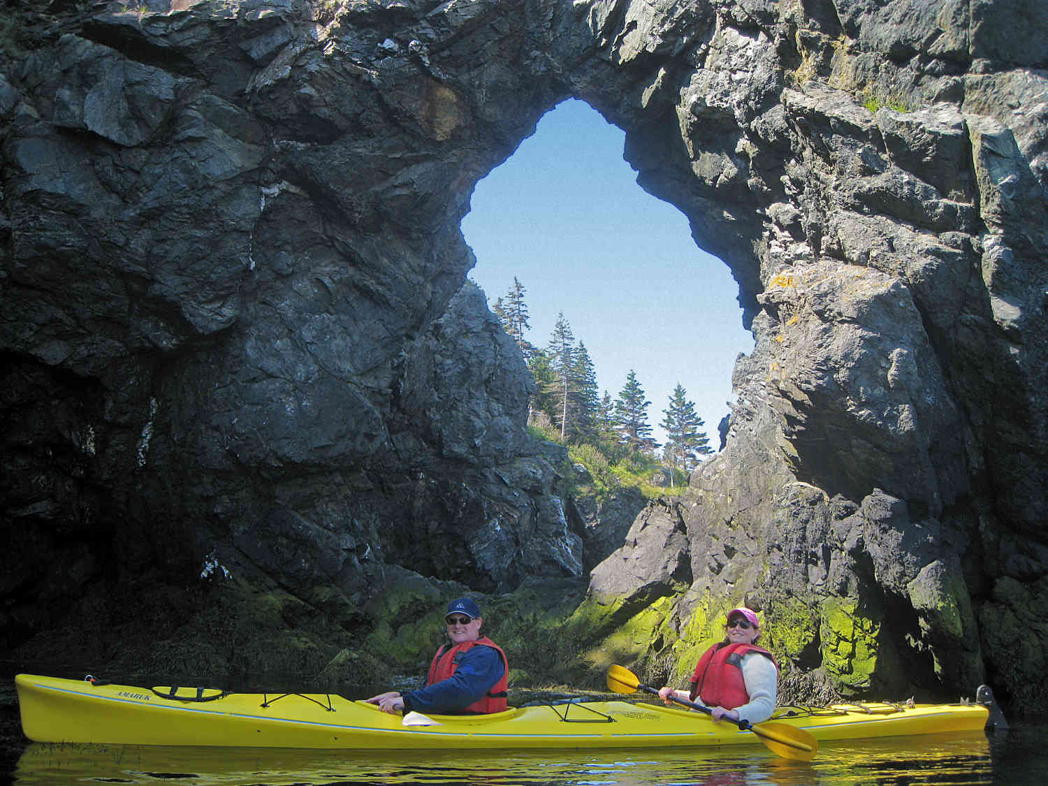 Kayakers at Hole-in-the-Wall, at Grand Manan in the Bay of Fundy, New Brunswick, Canada